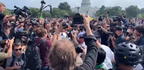Earlier in the preparation for the rally outside the Capitol in DC, rival protesters clashed before police intervened and the press rushed for photos.